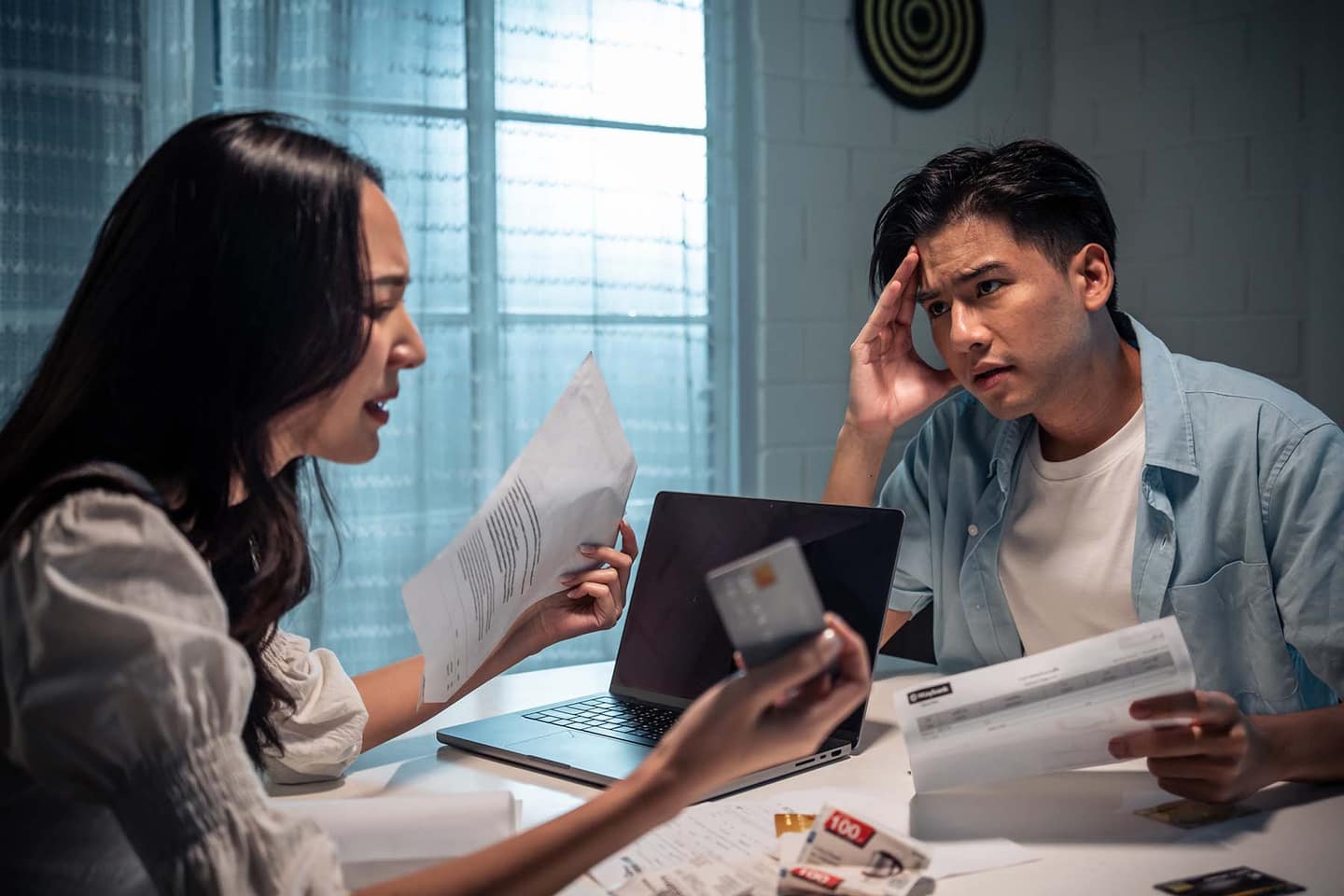 Frustrated couple reviewing bills