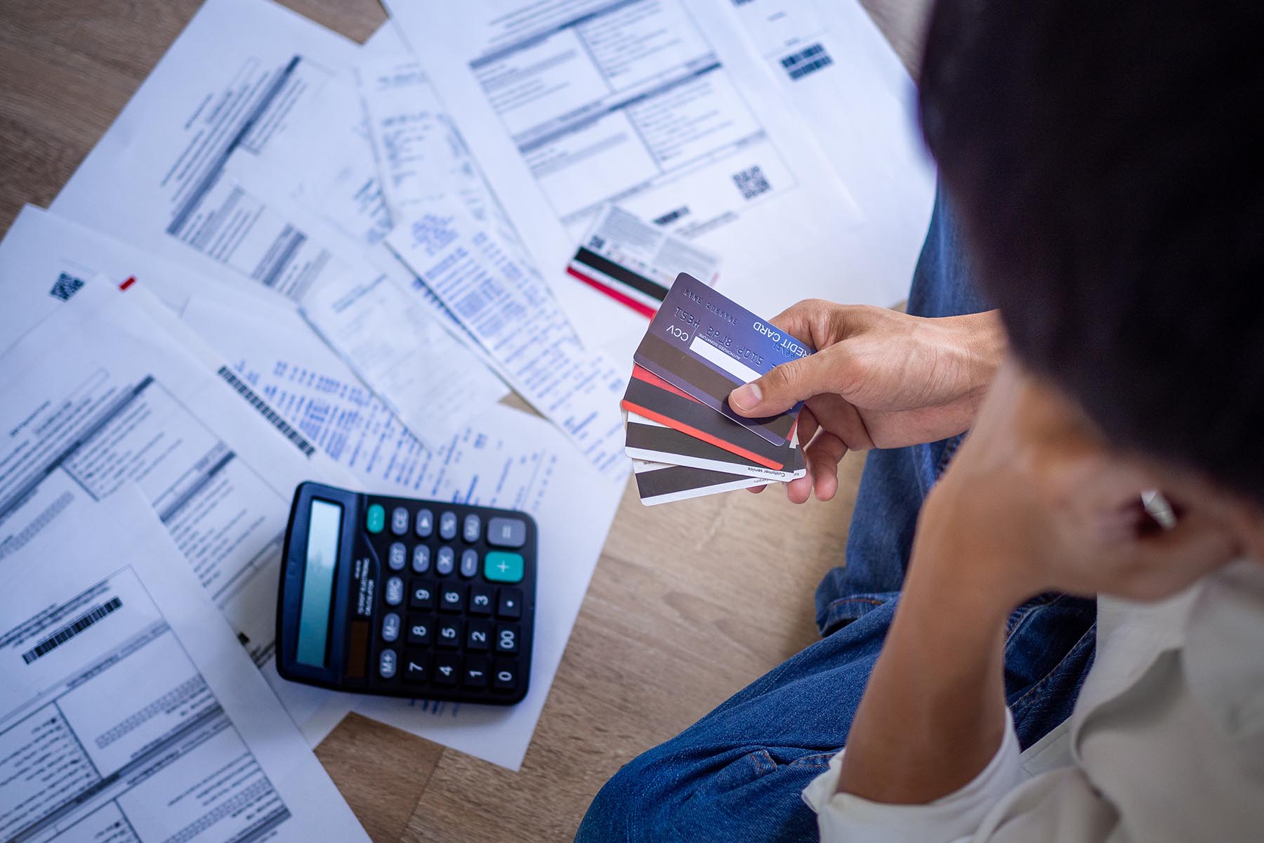 Person looking at stack of bills